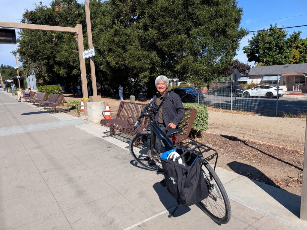 A man with a bike standing at a train station in Sunnyvale, California