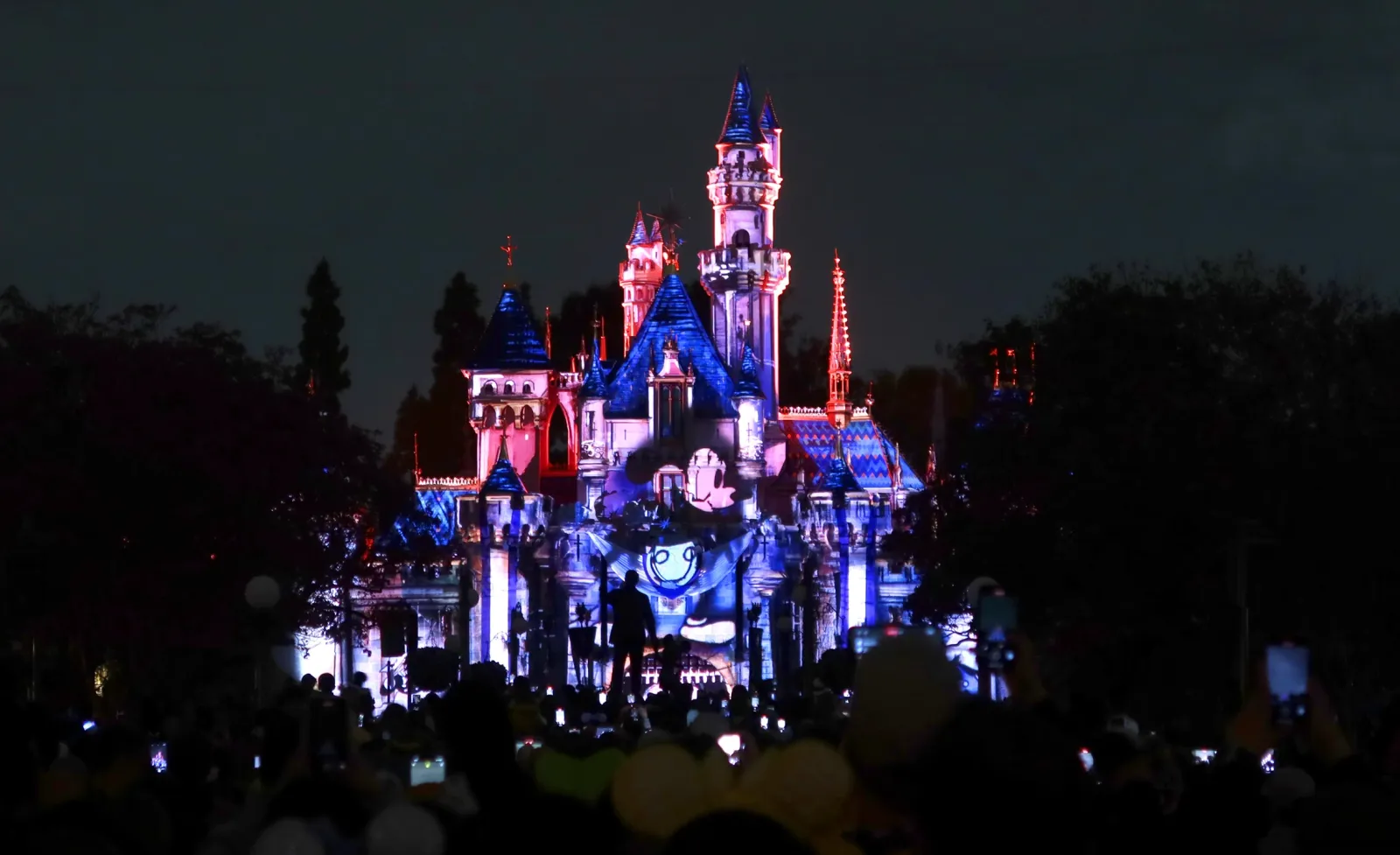 An image of Mickey Mouse is projected on front of the Sleeping Beauty Castle at the Disneyland theme park on April 13, 2023, in Anaheim, California.