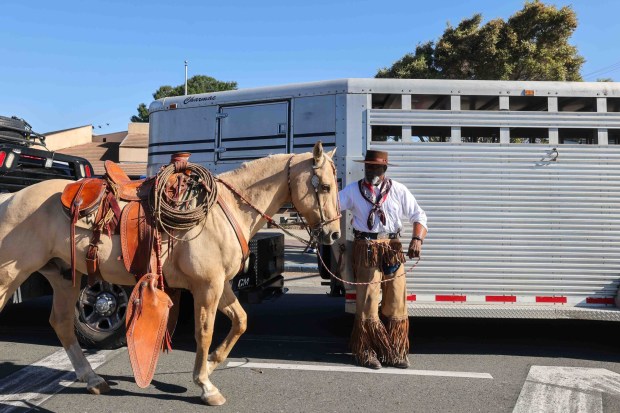 Pete Taylor prepares to ride his horse Bueno before participating in the Oakland Black Cowboy Association's 52nd Annual Parade and Festival at DeFremery Park in Oakland, Calif., on Saturday, Oct. 3, 2026. The event brought the community together under the theme "Preserving Our Heritage, Inspiring Our Future," featuring live entertainment, line dancing, youth activities, pony rides, food, local vendors and community resources. (Ray Chavez/Bay Area News Group)