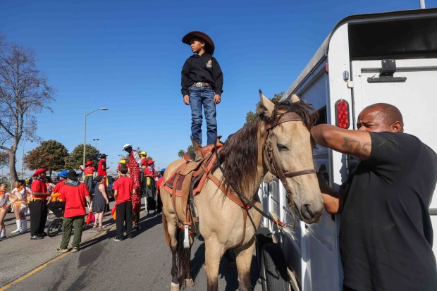 Bryant Jackson Jr., 6, of Oakland, stands still atop his horse while his father puts on the bridle before participating in the Oakland Black Cowboy Association's 52nd Annual Parade and Festival at DeFremery Park in Oakland, Calif., on Saturday, Oct. 3, 2026. The event brought the community together under the theme "Preserving Our Heritage, Inspiring Our Future," featuring live entertainment, line dancing, youth activities, pony rides, food, local vendors and community resources. (Ray Chavez/Bay Area News Group)