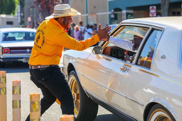Participants greet one another during the Oakland Black Cowboy Association's 52nd Annual Parade and Festival at DeFremery Park in Oakland, Calif., on Saturday, Oct. 3, 2026. The event brought the community together under the theme "Preserving Our Heritage, Inspiring Our Future," featuring live entertainment, line dancing, youth activities, pony rides, food, local vendors and community resources. (Ray Chavez/Bay Area News Group)