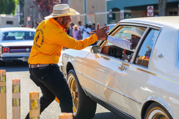 Participants greet one another during the Oakland Black Cowboy Association's 52nd Annual Parade and Festival at DeFremery Park in Oakland, Calif., on Saturday, Oct. 3, 2026. The event brought the community together under the theme "Preserving Our Heritage, Inspiring Our Future," featuring live entertainment, line dancing, youth activities, pony rides, food, local vendors and community resources. (Ray Chavez/Bay Area News Group)