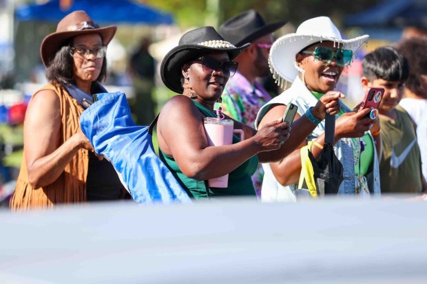 Spectators watch participants in the Oakland Black Cowboy Association's 52nd Annual Parade and Festival at DeFremery Park in Oakland, Calif., on Saturday, Oct. 3, 2026. The event brought the community together under the theme "Preserving Our Heritage, Inspiring Our Future," featuring live entertainment, line dancing, youth activities, pony rides, food, local vendors and community resources. (Ray Chavez/Bay Area News Group)