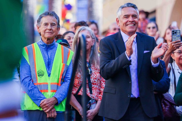 Oakland Councilmember Noel Gallo, left, and Unity Council President Chris Iglesias watch a dance performance by Ballet Folklórico de Fremont High School during the official welcome ceremony for La Catrina, a monumental 34-foot sculpture handcrafted in Mexico City and installed in the heart of the Fruitvale district in Oakland, Calif., on Thursday, Oct. 1, 2026. According to The Unity Council, the traditional Mexican art piece is the tallest Catrina sculpture in the United States, honoring culture, pride, remembrance, resilience, and generations of immigrants who empower and enrich the city. The ceremony featured speakers including Mayor Barbara Lee, Consul General of Mexico in San Francisco Marco Antonio Mena Rodriguez, and Visit Oakland President Peter Gamez, along with dance performances and live mariachi music. The sculpture will be on display through the annual Día de los Muertos festival. (Ray Chavez/Bay Area News Group)