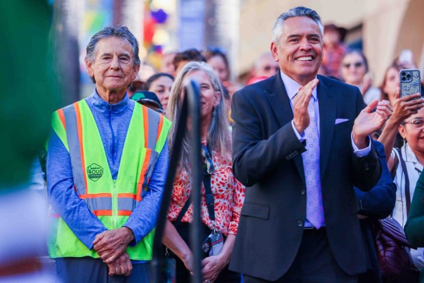 Oakland Councilmember Noel Gallo, left, and Unity Council President Chris Iglesias watch a dance performance by Ballet Folklórico de Fremont High School during the official welcome ceremony for La Catrina, a monumental 34-foot sculpture handcrafted in Mexico City and installed in the heart of the Fruitvale district in Oakland, Calif., on Thursday, Oct. 1, 2026. According to The Unity Council, the traditional Mexican art piece is the tallest Catrina sculpture in the United States, honoring culture, pride, remembrance, resilience, and generations of immigrants who empower and enrich the city. The ceremony featured speakers including Mayor Barbara Lee, Consul General of Mexico in San Francisco Marco Antonio Mena Rodriguez, and Visit Oakland President Peter Gamez, along with dance performances and live mariachi music. The sculpture will be on display through the annual Día de los Muertos festival. (Ray Chavez/Bay Area News Group)
