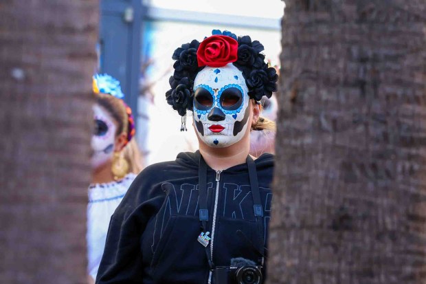Community members attend the official welcome ceremony for La Catrina, a monumental 34-foot sculpture handcrafted in Mexico City and installed in the heart of the Fruitvale district in Oakland, Calif., on Thursday, Oct. 1, 2026. According to The Unity Council, the traditional Mexican art piece is the tallest Catrina sculpture in the United States, honoring culture, pride, remembrance, resilience, and generations of immigrants who empower and enrich the city. The ceremony featured speakers including Mayor Barbara Lee, Councilmember Noel Gallo, Consul General of Mexico in San Francisco Marco Antonio Mena Rodriguez, Unity Council President Chris Iglesias, and Visit Oakland President Peter Gamez, along with dance performances and live mariachi music. The sculpture will be on display through the annual Día de los Muertos festival. (Ray Chavez/Bay Area News Group)