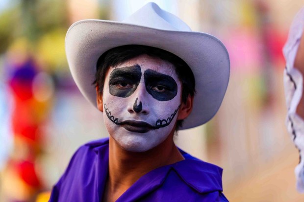 A member of Ballet Folklórico de Fremont High School performs during the official welcome ceremony for La Catrina, a monumental 34-foot sculpture handcrafted in Mexico City and installed in the heart of the Fruitvale district in Oakland, Calif., on Thursday, Oct. 1, 2026. According to The Unity Council, the traditional Mexican art piece is the tallest Catrina sculpture in the United States, honoring culture, pride, remembrance, resilience, and generations of immigrants who empower and enrich the city. The ceremony featured speakers including Mayor Barbara Lee, Councilmember Noel Gallo, Consul General of Mexico in San Francisco Marco Antonio Mena Rodriguez, Unity Council President Chris Iglesias, and Visit Oakland President Peter Gamez, along with dance performances and live mariachi music. The sculpture will be on display through the annual Día de los Muertos festival. (Ray Chavez/Bay Area News Group)