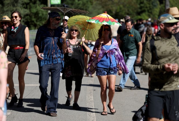 Festivalgoers shade themselves from the hot sun at the Hardly Strictly Bluegrass Festival in Golden Gate Park in San Francisco, Calif., on Saturday, Oct. 3, 2026. (Jane Tyska/Bay Area News Group)