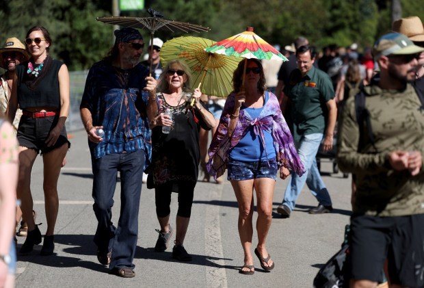Festivalgoers shade themselves from the hot sun at the Hardly Strictly Bluegrass Festival in Golden Gate Park in San Francisco, Calif., on Saturday, Oct. 3, 2026. (Jane Tyska/Bay Area News Group)