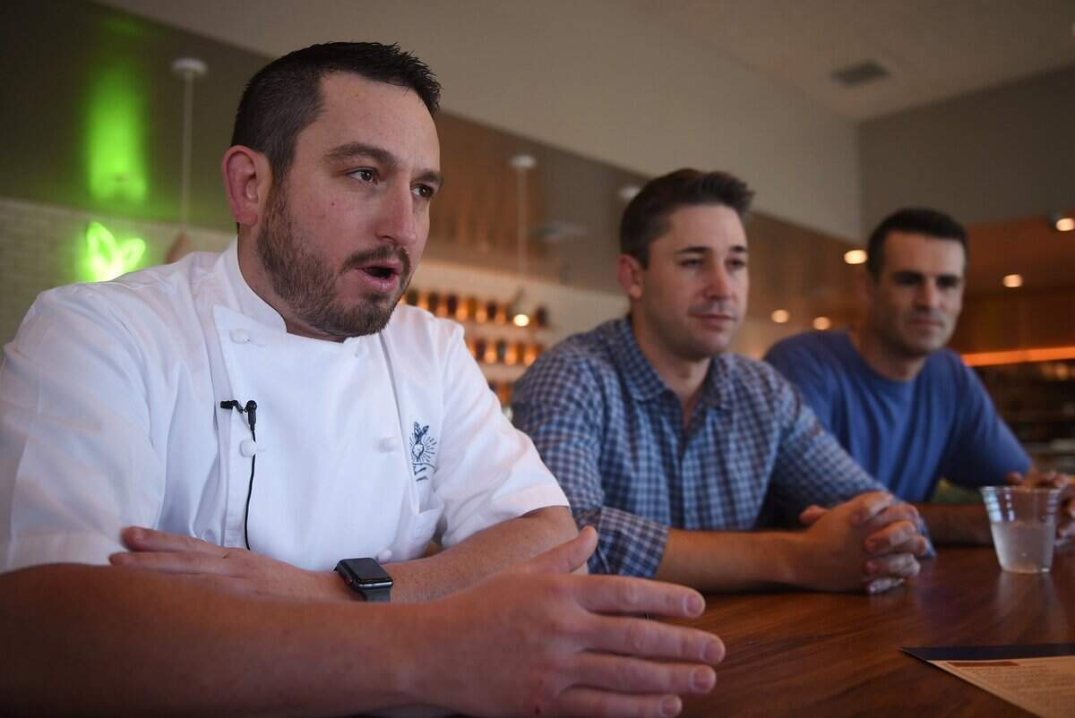 Heirloom chef and co-owner Justin Shannon, left, talks about the food served at Heirloom, with co-owners Brandon Smittcamp, center, and Kevin Koligian, right, Tuesday, Feb. 5, 2019 in Fresno.