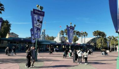 Pedestrians approach the Disneyland Resort entrance from Harbor Boulevard in Anaheim, California.