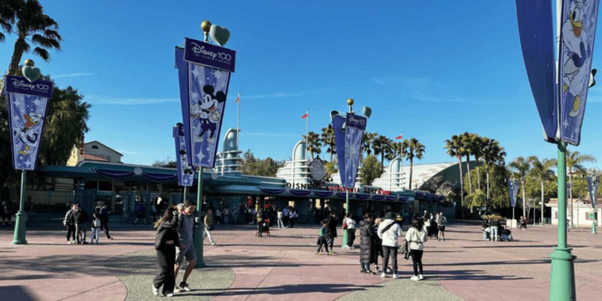 Pedestrians approach the Disneyland Resort entrance from Harbor Boulevard in Anaheim, California.