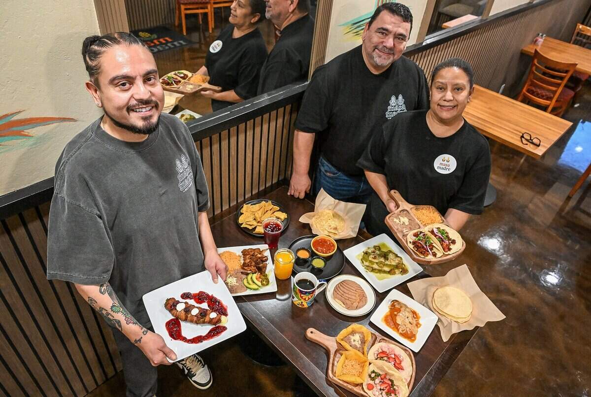 Bryan Hernandez, left, stands with his parents, Sandy and Jaime, along with several dishes at his new restaurant, Masa Madre, on the northeast corner of Palm and Bullard in Fresno. Hernandez's parents had El Mariachi and helped him get his new restaurant started.