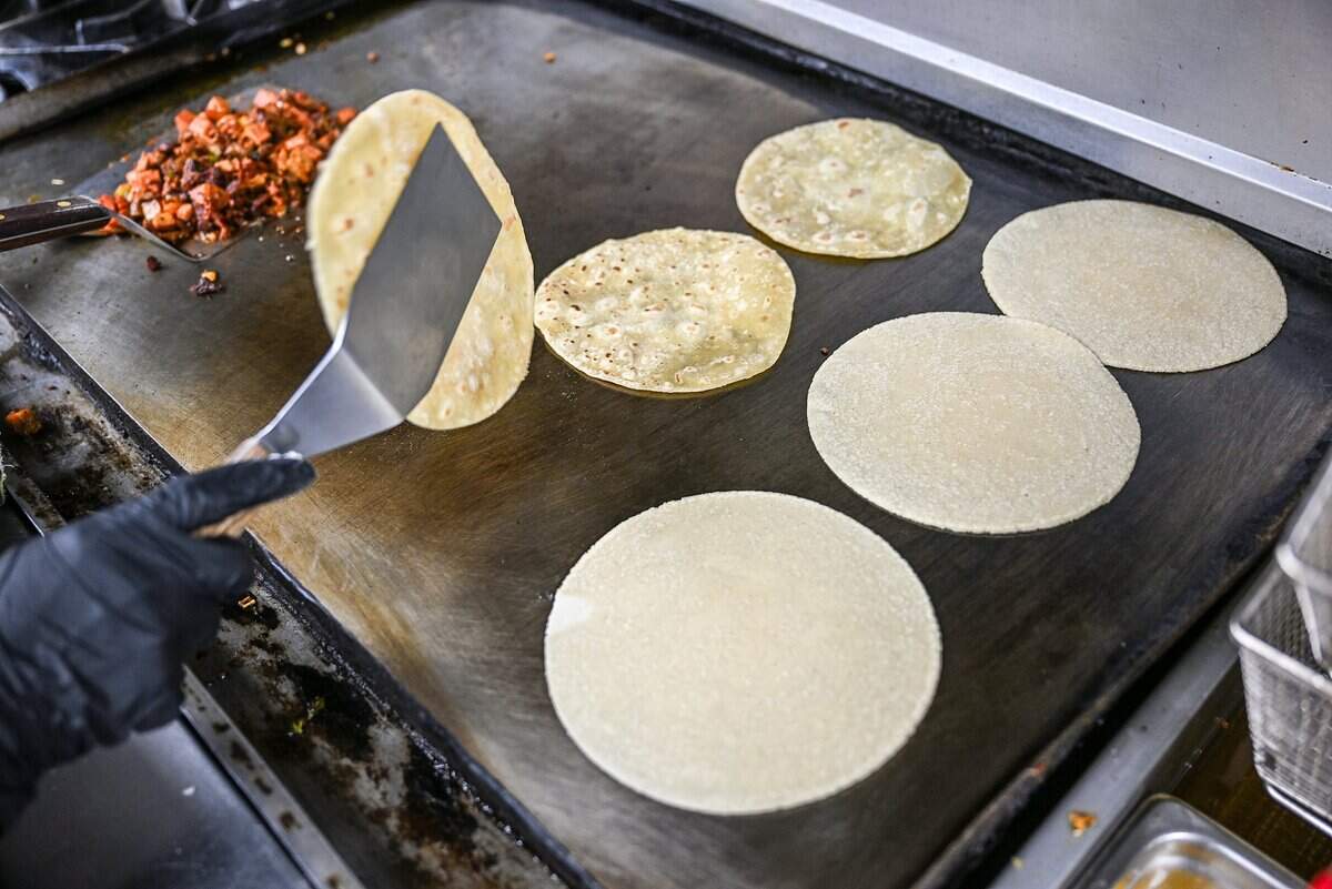 Homemade tortillas are flipped on the griddle at Masa Madre, a New Mexican restaurant on the northeast corner of Palm and Bullard in Fresno.