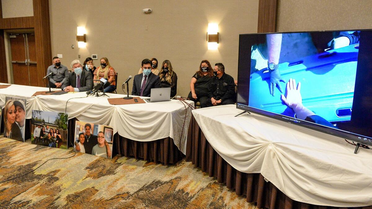 Lawyers John Taylor and Neil Gehlawat sit with members of Joseph Perez’s family while they watch a May 2017 police body camera video capturing officers using a backboard to restrain Joseph Perez before he died.