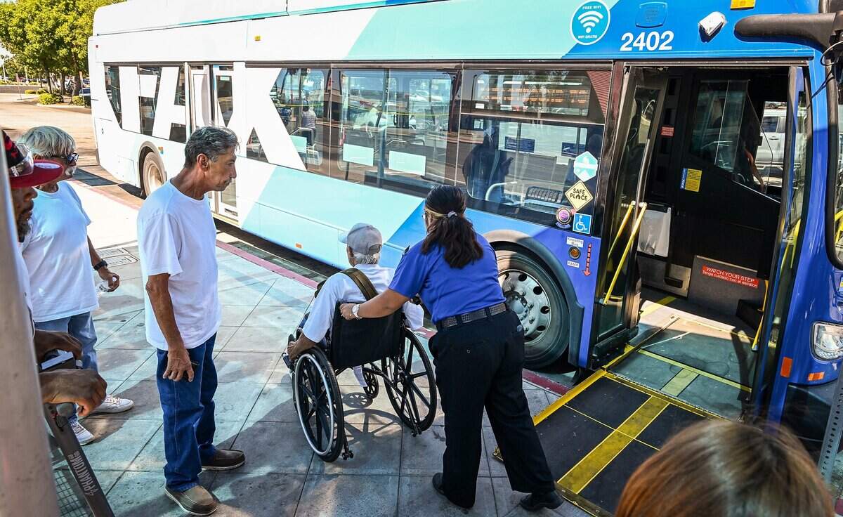 A Fresno Area Express, or FAX, bus driver helps a disabled person off a bus at the Manchester Transit Center on Wednesday, July 22, 2026. FAX is the primary public mass transit system serving the City of Fresno and parts of neighboring Clovis, California. The system is operated by the city's Department of Transportation which manages a fleet of over 100 buses that operate across nearly 20 fixed routes.