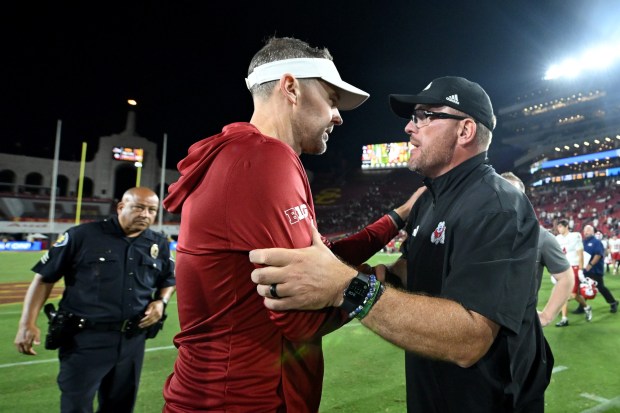 USC head coach Lincoln Riley, left, and Fresno State head coach Matt Entz shake hands after the game on Friday, Sept. 4, 2026, at the Coliseum. (Photo by Griffin C. Hooper/Getty Images)