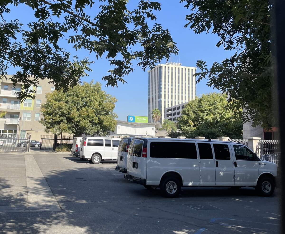 White vans in a parking lot behind the ICE office in downtown Fresno on Tuesday, Oct. 6, 2026. Volunteers with the Valley Watch network say they’ve counted 13 white vans they believe are used to transport detained individuals to and from immigration detention facilities.