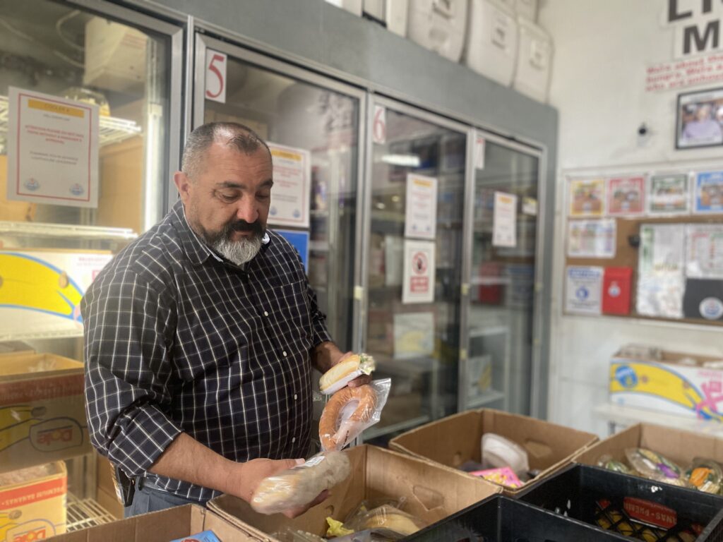 A man looking at produce at a food pantry in San Jose, California