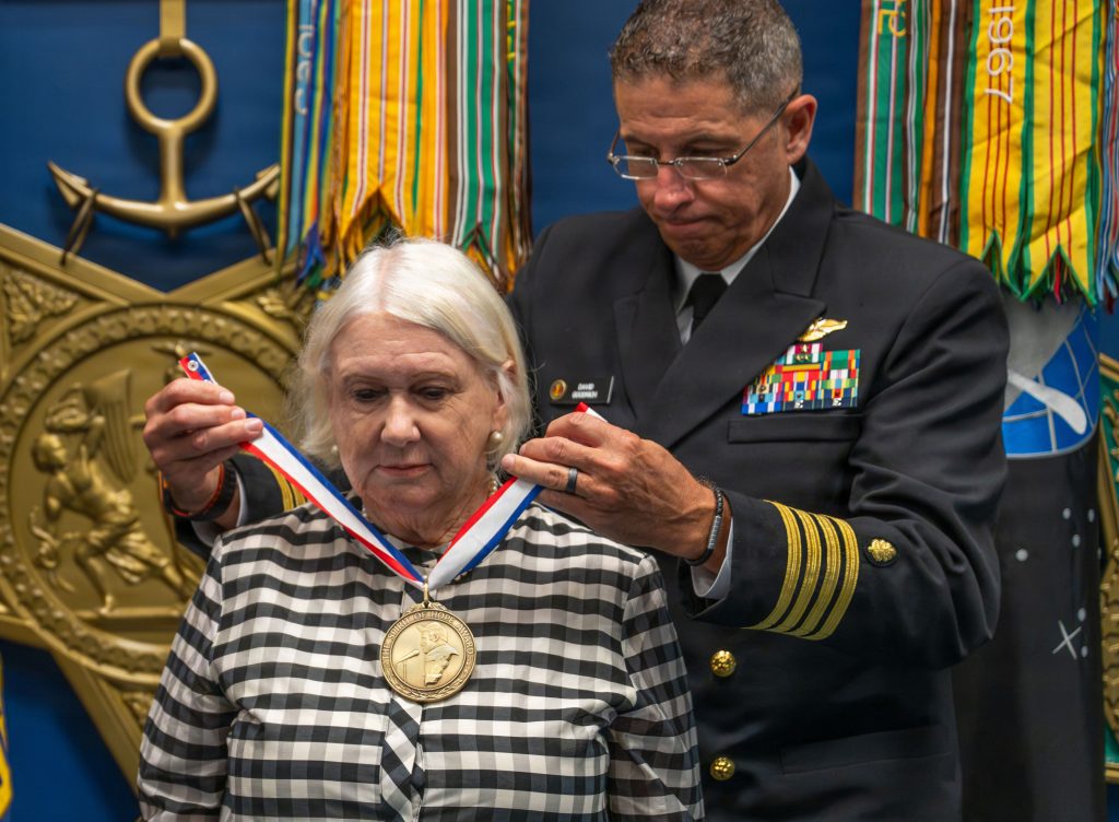 Karol McClelland, President of Coronado Rotary Club, receives a medallion during the 2026 Spirit of Hope (SoH) Award ceremony in the Pentagon Hall of Heroes in Arlington, Virginia, Sept. 23, 2026. Robert Salesses, Department of War Director of Administration and Management, hosted the event. (U.S. Army photo by Christopher Kaufmann)