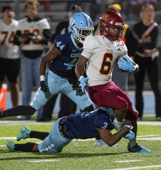Compton's Nathaniel Willard trips up Wilson's Kyle Harris on a carry during Friday's nonleague game at Compton High School on Friday, September 25, 2026. (Photo by Miguel Vasconcellos, Contributing Photographer)