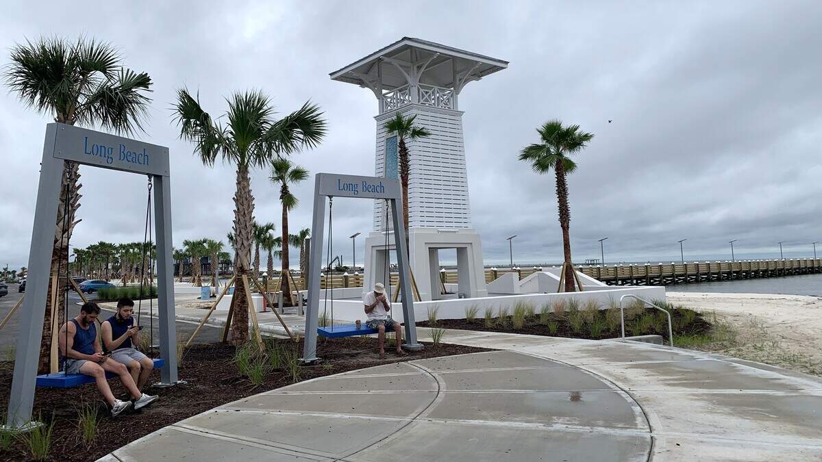 Long Beach, MS, gateway opens with swings and palm trees