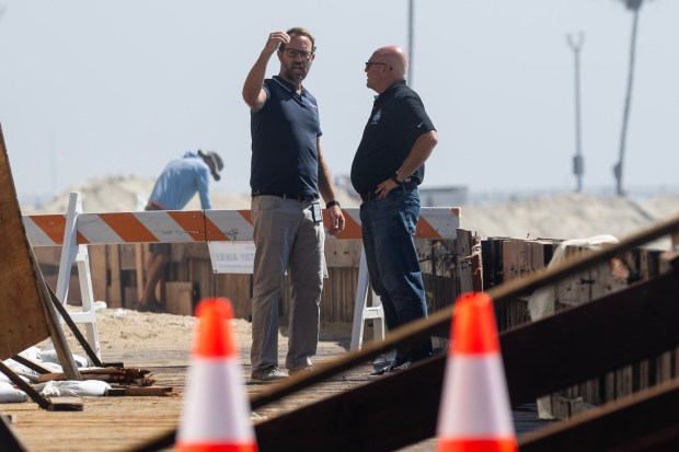 Marine Bureau Manager Todd Leland, left, assesses the damage to the oceanfront bulkhead along the Long Beach Peninsula on Thursday, October 8, 2026. (Photo by Drew A. Kelley, Press-Telegram/SCNG)