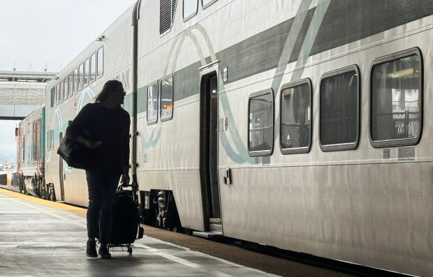A rider boards a northbound Metrolink train in Anaheim in May 2026. Battered by huge drops in ridership and bleeding cash, Metrolink has proposed service cuts in Orange County (Photo by Jeff Gritchen, Orange County Register/SCNG)