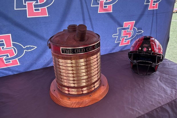 The Old Oil Can trophy has become a big deal in SDSU-Fresno State rivalry. (Kirk Kenney / San Diego Union-Tribune)