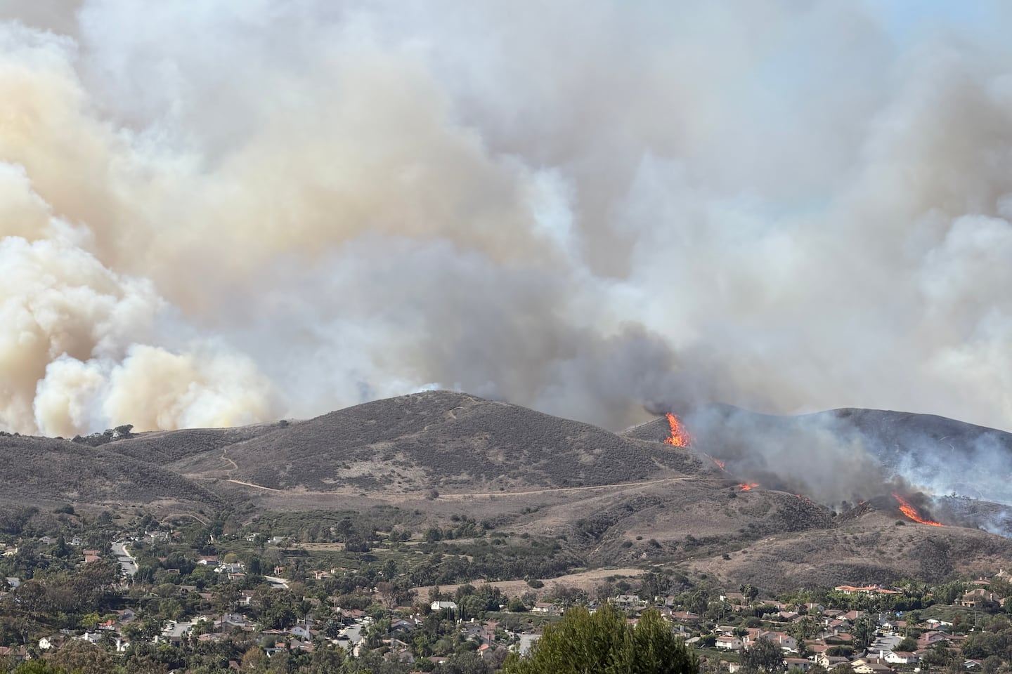 This photo provided by Cameron Cosgrove shows smoke billowing up from the Norte fire in San Clemente, Calif., on Oct. 16, 2026.