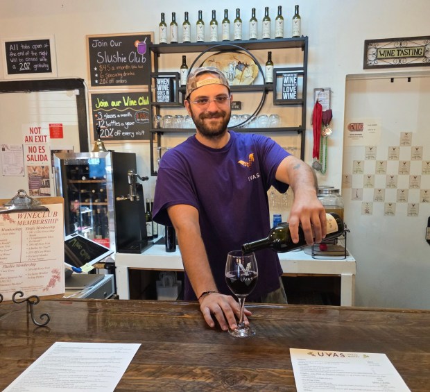 Tristian Zaldivar pours wine that he helped make from grapes sourced locally. (Julie Gallant)