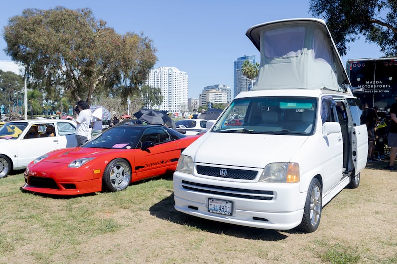 A sports car next to a camper van