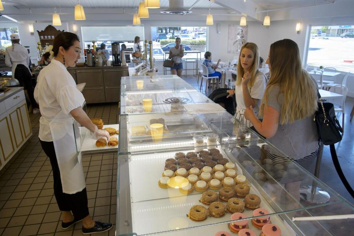 Sunghee Kang helps customers Lyuda Klymets of Washington and Dina Ustymchuk of Sacramento at Estelle Bakery & Patisserie on Arden Way on Tuesday, June 12, 2018.