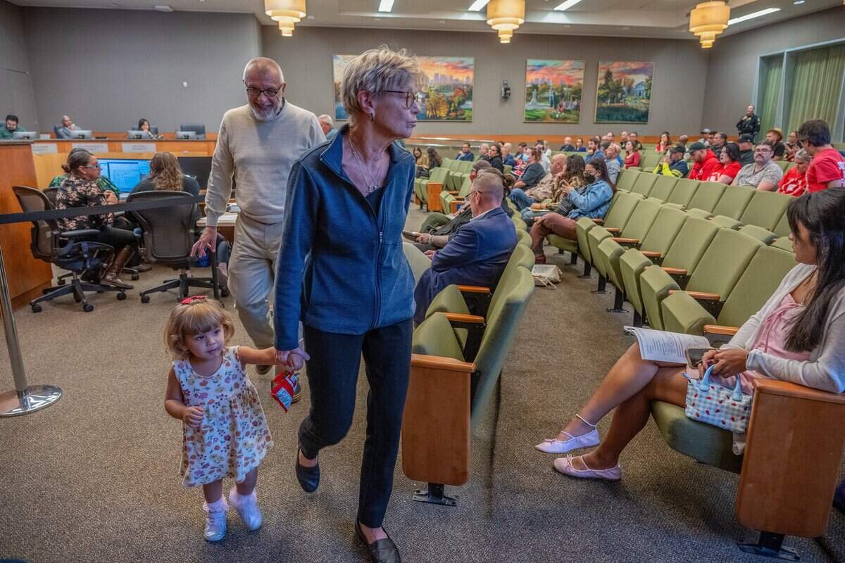 Laura Carlisle is led back to her seat after her adoptive parents, Anne Marie Carlisle and Christopher Carlisle, spoke at a Sacramento City Council behavioral health workshop on Tuesday. The Carlisles adopted Laura in March and attended the workshop to speak on behalf of Christopher’s daughter, Califia Carlisle, who is homeless and has been diagnosed with schizophrenia.
