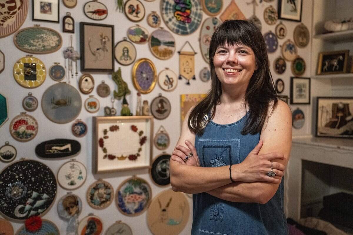 Corinna Fish stands with her embroidery collection at her Sacramento home in September.