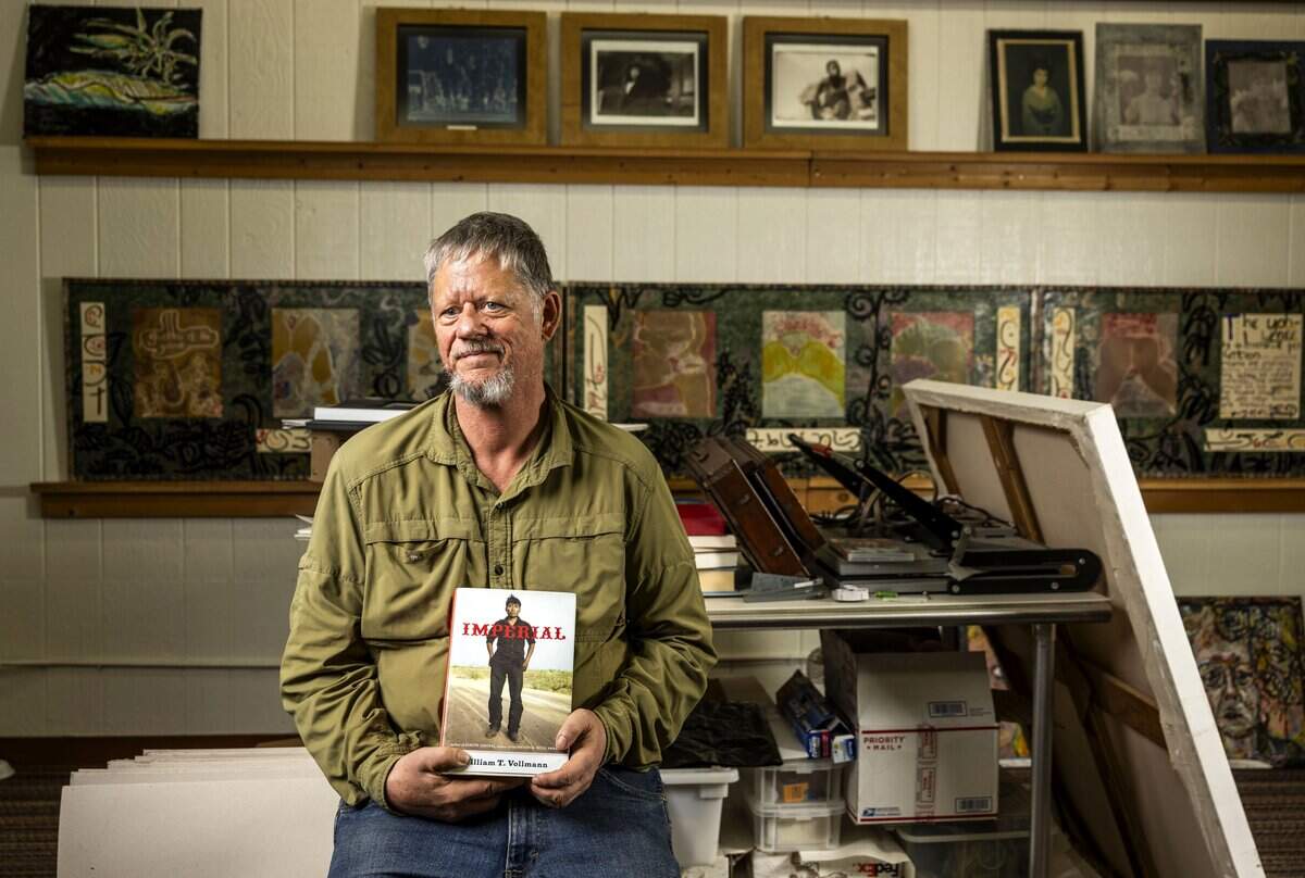 Sacramento novelist and journalist William T. Vollmann holds a copy of his book “Imperial” at his Sacramento studio in September. Vollmann’s latest release is a four-volume novel titled “A Table for Fortune.”
