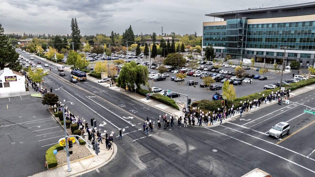 SEIU Local 1000 members participate in a one-day California state workers strike near the DMV headquarters on Broadway on Wednesday, Oct. 21, 2026.