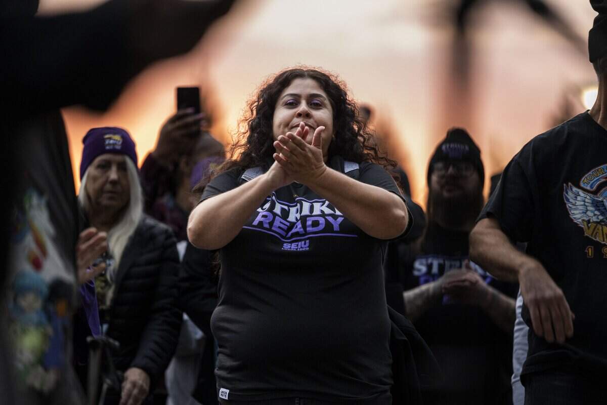 Araceli Ramos, an SEIU Local 1000 member, participates in a one-day California state workers strike near the DMV headquarters on Broadway on Wednesday, Oct. 21, 2026.