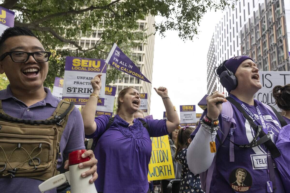 SEIU Local 1000 members march down P Street in Sacramento during a statewide one-day California state worker strike on Wednesday, Oct. 21, 2026.
