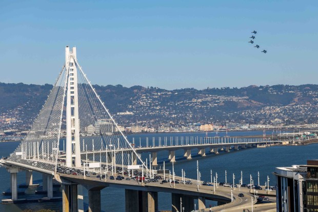 The U.S. Navy Blue Angels fly over the Bay Bridge and the San Francisco Bay during a practice flight for San Francisco Fleet Week, as seen from Treasure Island in San Francisco, Calif., on Thursday, Oct. 8, 2026. (Ray Chavez/Bay Area News Group)