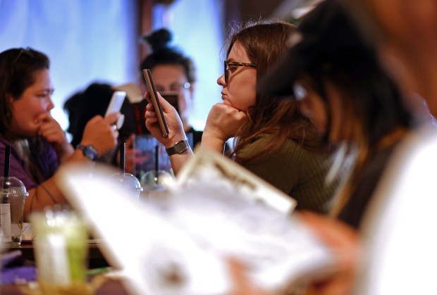 Cleo Brock, center, a moderator with the San Jose Silent Book Club takes part in a reading session at a cafe on Sunday, July 26, 2026, in Campbell, Calif. (Aric Crabb/Bay Area News Group)