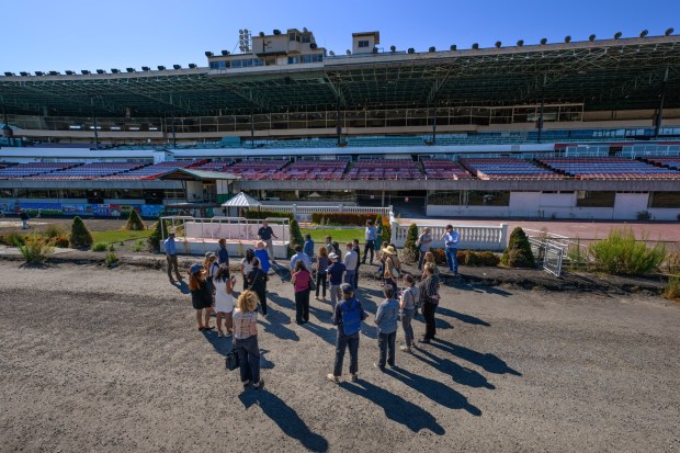 A group of public officials and their staff members stand in front of the winner's circle during a site tour of the Golden Gate Fields in Albany, Calif., on Monday, Oct. 5, 2026. The historic horse racing track closed in 2024 after 83 years of racing and will be converted into a new bayfront public park. (Jose Carlos Fajardo/Bay Area News Group)