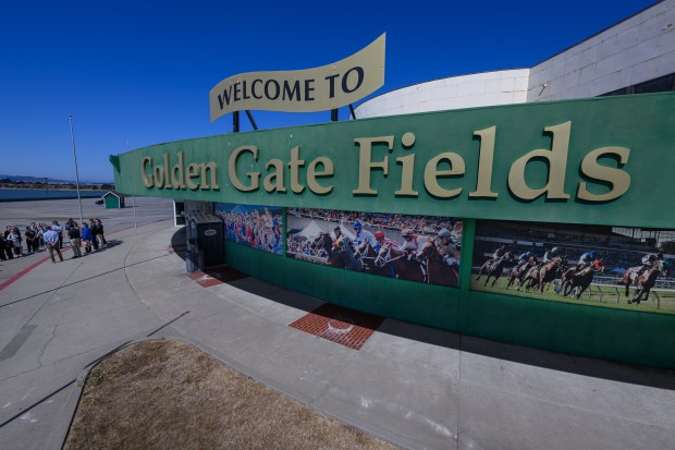 A group of public officials and their staff members walk to the front entrance of the Golden Gate Fields during a site tour in Albany, Calif., on Monday, Oct. 5, 2026. The historic horse racing track closed in 2024 after 83 years of racing and will be converted into a new bayfront public park. (Jose Carlos Fajardo/Bay Area News Group)