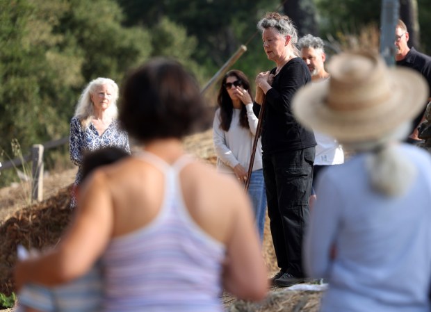 Janice Thomas ,center, speaks during a community gathering on Sunday, Oct. 4, 2026 in Oakland, Calif. Over 40 community members gathered in the Oakland hills above the campus of UC Berkeley to remember their neighbors Bryan Walker and his wife Michelle Min who were shot and killed on Friday. (Aric Crabb/Bay Area News Group)