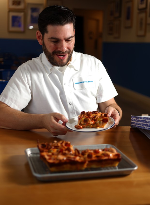 Square Pie Guys founder Marc Schechter holds a plate of Spicy Pepperoni pizza in the dining room of his Walnut Creek restaurant on Sept. 22, 2026. (Aric Crabb/Bay Area News Group)
