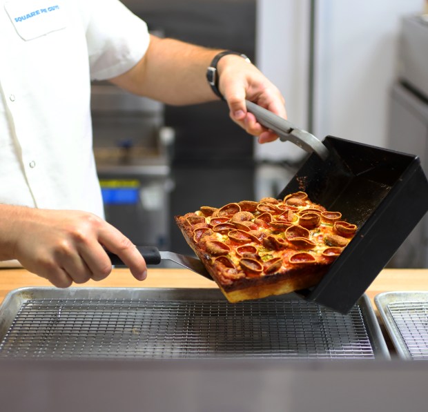 Square Pie Guys founder Marc Schechter slides The Spicy Pepperoni pizza out of a cooking pan and onto a cooling rack in his Walnut Creek restaurant on Sept. 22, 2026. (Aric Crabb/Bay Area News Group)