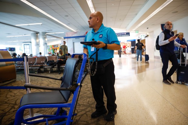 Denis Robles, who works with Menzies, pushes a wheelchair to a gate at San Jose Mineta International Airport in San Jose, Calif., on Thursday, Sept. 17, 2026. (Shae Hammond/Bay Area News Group)