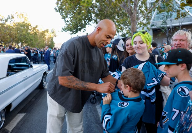 San Jose Sharks' Darnell Nurse (25) signs autographs during the Teal Carpet arrivals before their first home game against the Florida Panthers at the SAP Center in San Jose, Calif., on Thursday, Oct. 1, 2026. (Nhat V. Meyer/Bay Area News Group)