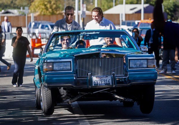 San Jose Sharks' Alexander Wennberg (21), top left, San Jose Sharks' Tyler Toffoli (73), top right, and San Jose Sharks' Mason Marchment (27), bottom left, ride in a lowrider from the United Lowrider Council of San Jose during the Teal Carpet arrivals before their first home game against the Florida Panthers at the SAP Center in San Jose, Calif., on Thursday, Oct. 1, 2026. (Nhat V. Meyer/Bay Area News Group)
