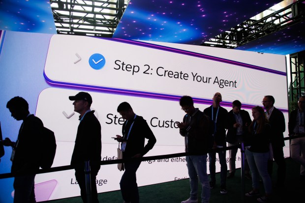 Attendees wait in line in front of a display showcasing "Agentforce," Salesforce's new tool for autonomous AI agents, during the Dreamforce conference in San Francisco in 2024. (Dai Sugano/Bay Area News Group)